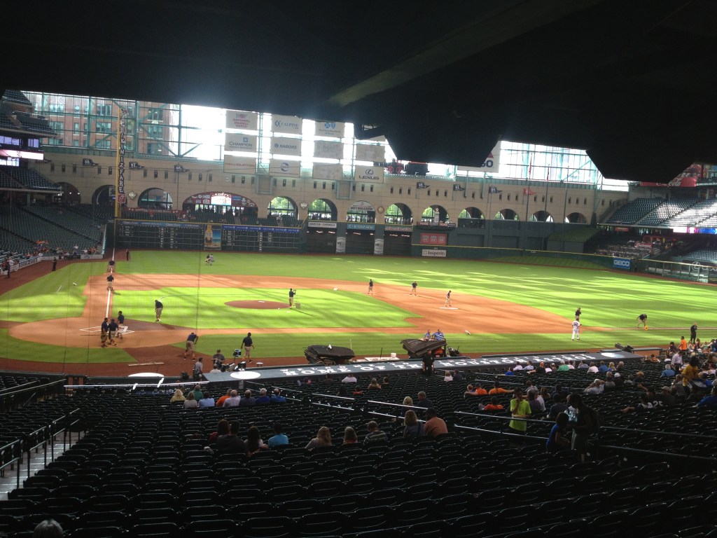 The baseball field with shadows of the roof struts over the grass