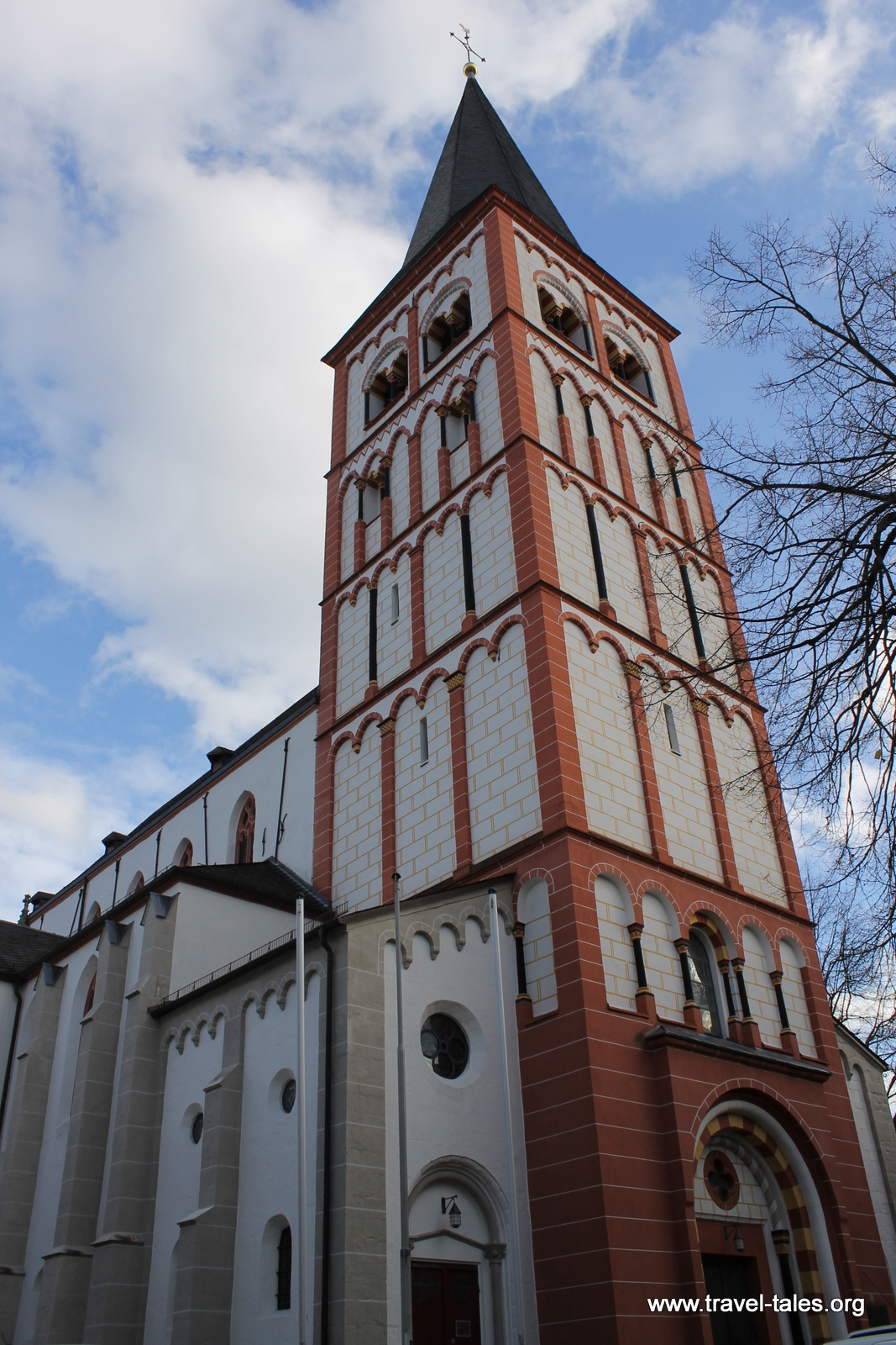Red and white church tower from ground level